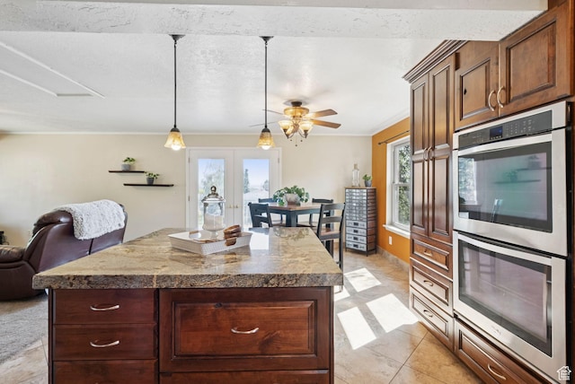 2999 N 300 E, North Ogden, UT 84414 - kitchen featuring double oven, healthy amount of natural light, ornamental molding, hanging light fixtures, and a center island