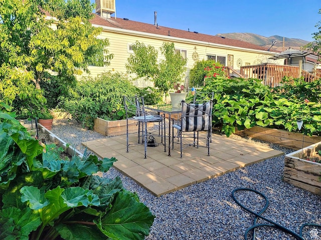 856 S 860 W, Tooele, UT 84074 - view of patio / terrace featuring a vegetable garden and a wooden deck