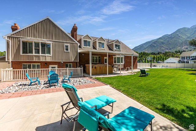 2148 E Pinecrest Ln S, Sandy, UT 84092 - rear view of property featuring a hot tub, brick siding, a patio, a mountain view, and a fenced backyard