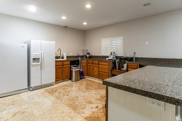 2148 E Pinecrest Ln S, Sandy, UT 84092 - kitchen featuring white refrigerator with ice dispenser, tile counters, brown cabinetry, freestanding refrigerator, and recessed lighting