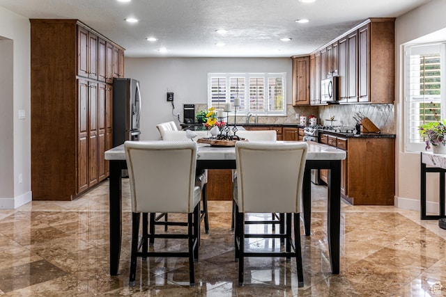 2148 E Pinecrest Ln S, Sandy, UT 84092 - kitchen featuring stainless steel appliances, recessed lighting, dark countertops, decorative backsplash, and light marble finish flooring