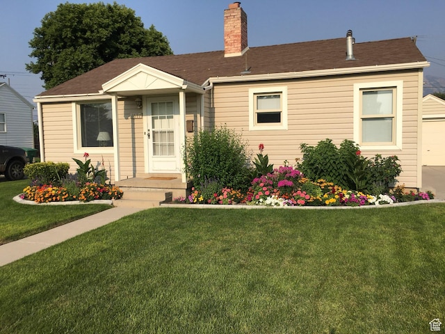 4617 S Box Elder W, Murray, UT 84107 - view of front facade with a front yard, a chimney, and a garage