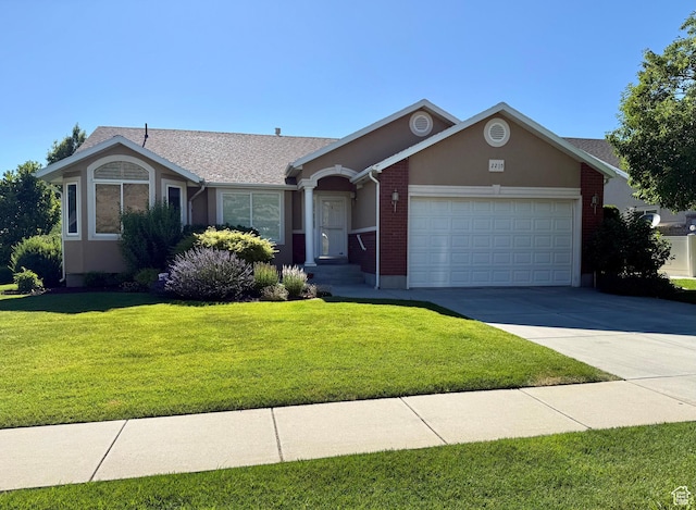 2205 N 600 E, North Ogden, UT 84414 - single story home with a garage, a front yard, concrete driveway, brick siding, and stucco siding