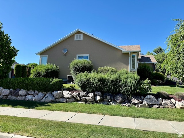 2205 N 600 E, North Ogden, UT 84414 - view of side of home with stucco siding and a lawn