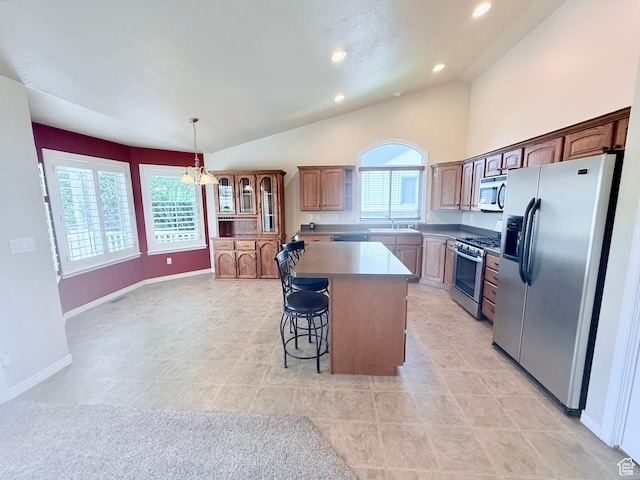 2205 N 600 E, North Ogden, UT 84414 - kitchen featuring appliances with stainless steel finishes, a kitchen island, plenty of natural light, a kitchen breakfast bar, and recessed lighting