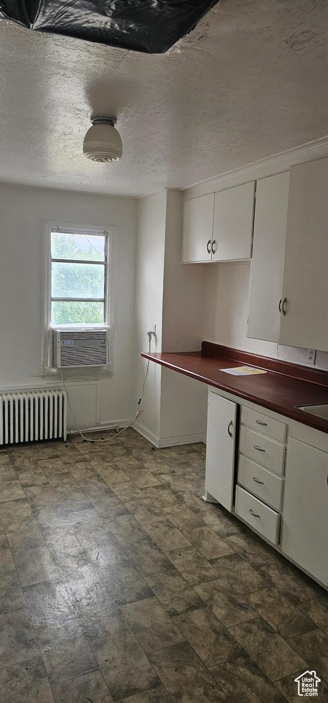 40 W 400 N Unit 1-6, Spanish Fork, UT 84660 - kitchen featuring radiator, dark countertops, white cabinets, cooling unit, and a textured ceiling