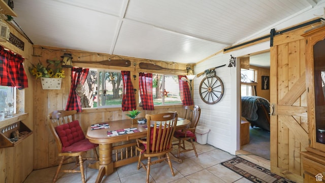 180 N State St, Sigurd, UT 84657 - dining area with plenty of natural light, wood walls, a barn door, and tile patterned flooring