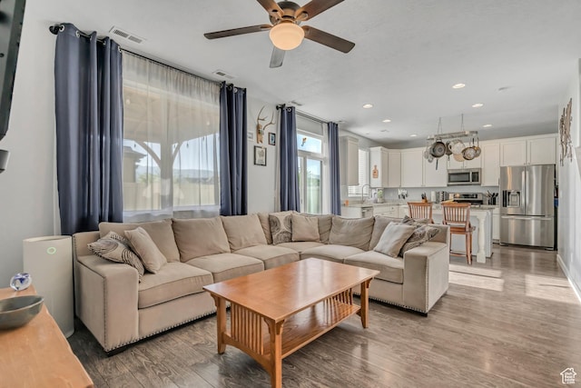 1046 W Stonehaven Dr, North Salt Lake, UT 84054 - living area featuring ceiling fan, light wood-style floors, and recessed lighting