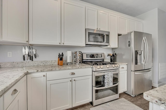 1046 W Stonehaven Dr, North Salt Lake, UT 84054 - kitchen with stainless steel appliances, white cabinets, light wood finished floors, and light stone counters