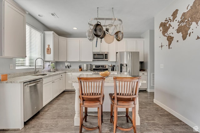 1046 W Stonehaven Dr, North Salt Lake, UT 84054 - kitchen featuring appliances with stainless steel finishes, wood finished floors, white cabinetry, and recessed lighting