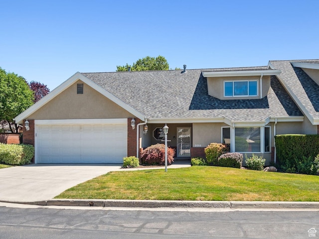 2056 E Sierra View Cir, Millcreek, UT 84109 - view of front of house with stucco siding, a front lawn, driveway, an attached garage, and roof with shingles