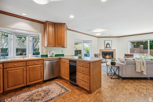 2056 E Sierra View Cir, Millcreek, UT 84109 - kitchen with stainless steel dishwasher, a peninsula, crown molding, brown cabinets, and a tile fireplace