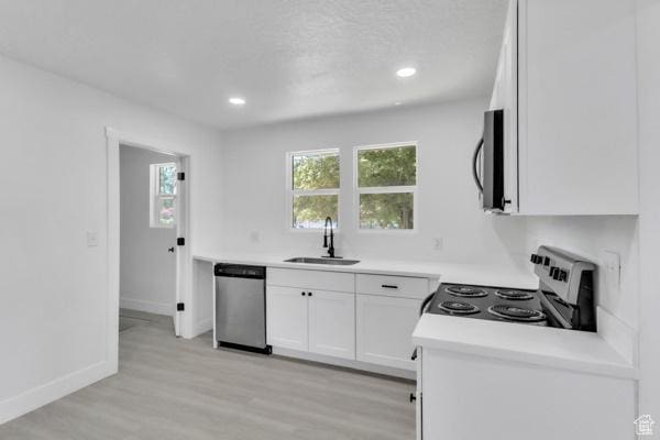 9593 S 700 E, Sandy, UT 84070 - kitchen featuring appliances with stainless steel finishes, white cabinetry, light wood-style floors, light countertops, and recessed lighting