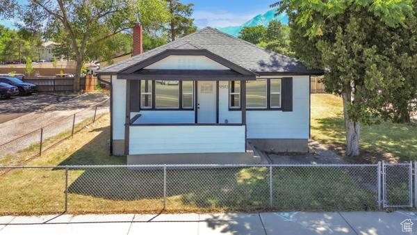9593 S 700 E, Sandy, UT 84070 - bungalow with a chimney and a fenced front yard