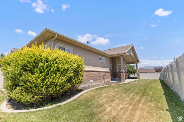 4713 W 4050 S, West Haven, UT 84401 - back of property with brick siding, a fenced backyard, and stucco siding