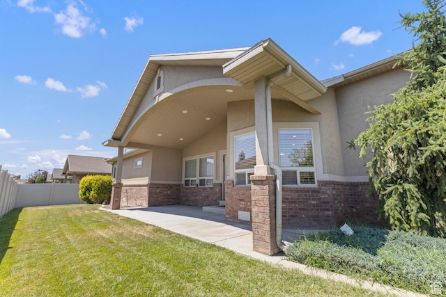 4713 W 4050 S, West Haven, UT 84401 - view of front of property featuring stucco siding, brick siding, and a patio