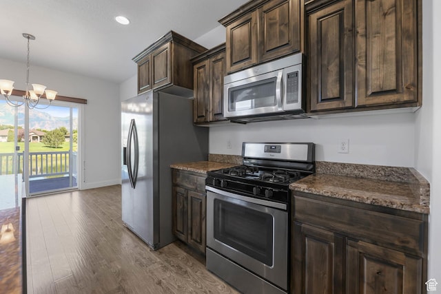 947 S 2040 W, Orem, UT 84059 - kitchen featuring appliances with stainless steel finishes, wood finished floors, dark brown cabinets, a chandelier, and recessed lighting