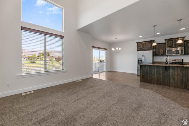 947 S 2040 W, Orem, UT 84059 - unfurnished living room featuring a chandelier, dark colored carpet, and recessed lighting