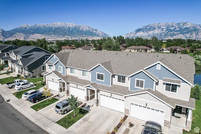 947 S 2040 W, Orem, UT 84059 - view of front of property featuring driveway, a garage, stone siding, a mountain view, and roof with shingles