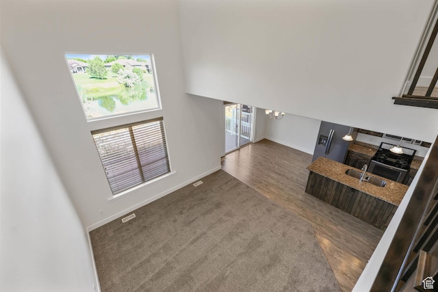 947 S 2040 W, Orem, UT 84059 - unfurnished living room featuring a chandelier, wood finished floors, and a high ceiling