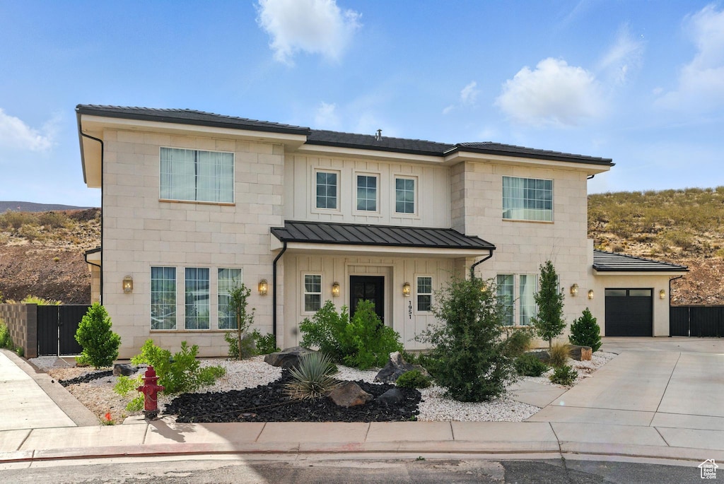 1952 W Cedar Breaks Dr W, Hurricane, UT 84737 - view of front facade with concrete driveway, a standing seam roof, an attached garage, and a metal roof