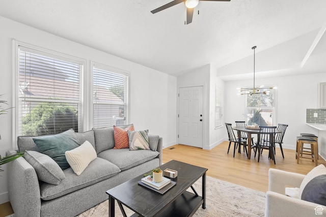 1215 W 125 S, Lehi, UT 84043 - living room featuring healthy amount of natural light, vaulted ceiling, a chandelier, ceiling fan, and light wood-type flooring