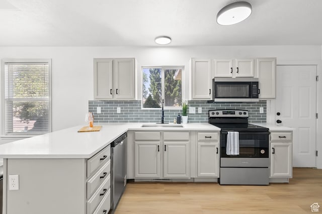 1215 W 125 S, Lehi, UT 84043 - kitchen with stainless steel appliances, a peninsula, healthy amount of natural light, and light countertops