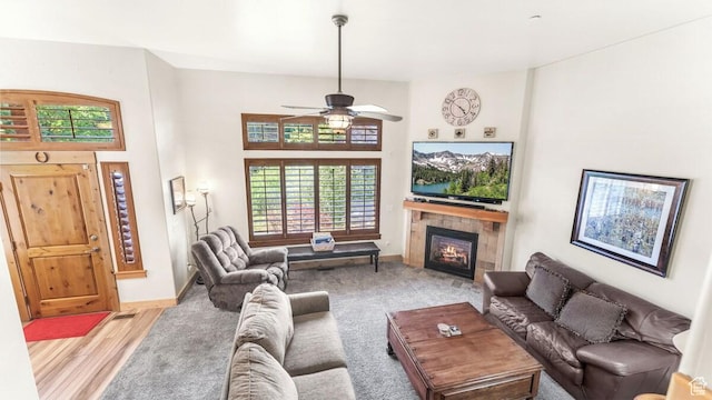 5541 N Slalom Way, Park City, UT 84098 - living room featuring a fireplace, a ceiling fan, light wood-style flooring, and a towering ceiling
