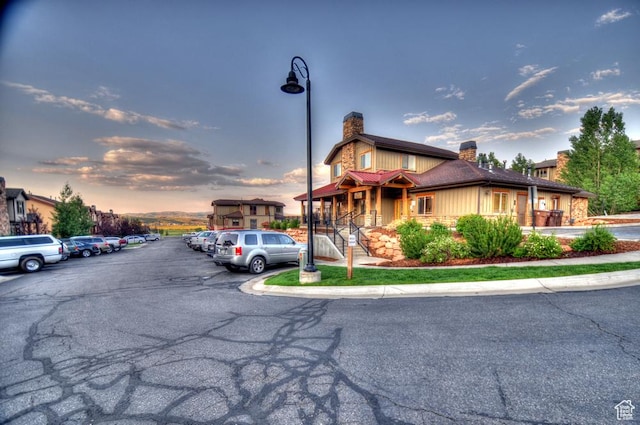 5541 N Slalom Way, Park City, UT 84098 - view of front of house featuring a chimney and uncovered parking