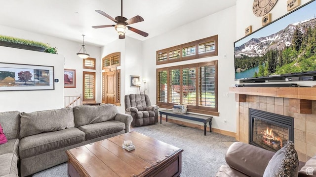 5541 N Slalom Way, Park City, UT 84098 - carpeted living area featuring a tiled fireplace, a ceiling fan, and a high ceiling