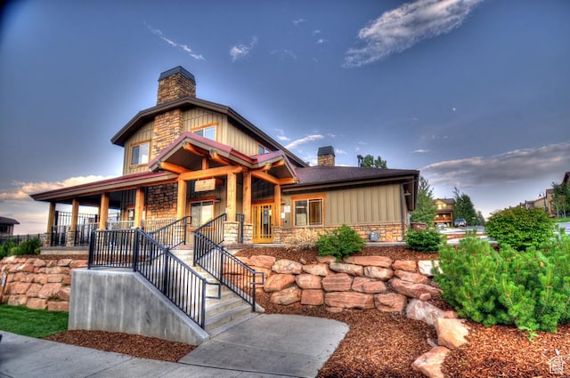 5541 N Slalom Way, Park City, UT 84098 - view of front of home featuring a chimney, covered porch, stone siding, and board and batten siding