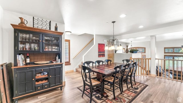 5541 N Slalom Way, Park City, UT 84098 - dining room with light wood-type flooring, a chandelier, recessed lighting, stairs, and a dry bar