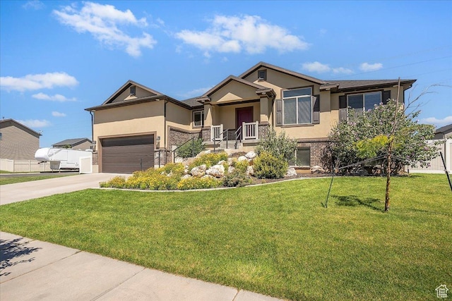 5464 S 3200 W, Roy, UT 84067 - view of front of house with stucco siding, driveway, a front lawn, brick siding, and a garage