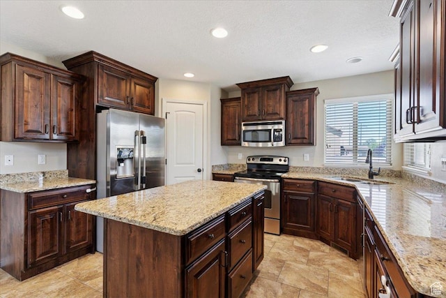 5464 S 3200 W, Roy, UT 84067 - kitchen with stainless steel appliances, recessed lighting, a center island, dark brown cabinets, and light stone counters