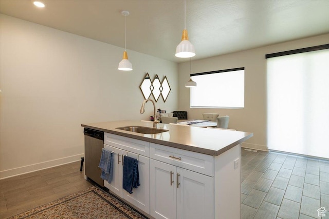 2049 N Harvest Village Ln, Saratoga Springs, UT 84045 - kitchen featuring stainless steel dishwasher, white cabinetry, a kitchen island with sink, hanging light fixtures, and light wood-style flooring