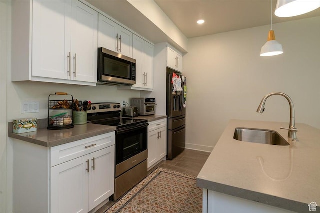 2049 N Harvest Village Ln, Saratoga Springs, UT 84045 - kitchen featuring stainless steel appliances, white cabinetry, recessed lighting, decorative light fixtures, and wood finished floors