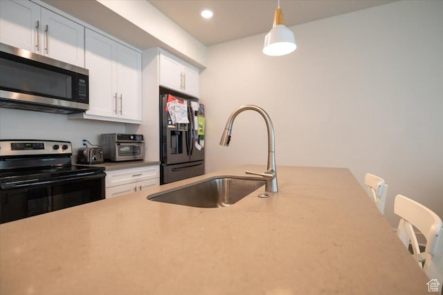 2049 N Harvest Village Ln, Saratoga Springs, UT 84045 - kitchen with appliances with stainless steel finishes, white cabinetry, hanging light fixtures, and recessed lighting