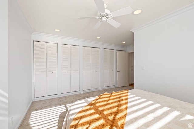 777 E S Temple Unit 4A, Salt Lake City, UT 84102 - unfurnished bedroom with ornamental molding, two closets, recessed lighting, light carpet, and a ceiling fan