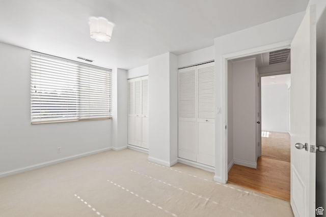 777 E S Temple Unit 4A, Salt Lake City, UT 84102 - unfurnished bedroom featuring carpet and two closets