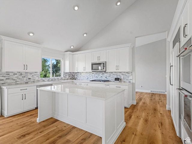 2960 E Oak Park Ln S, Holladay, UT 84117 - kitchen featuring appliances with stainless steel finishes, backsplash, light countertops, white cabinets, and recessed lighting