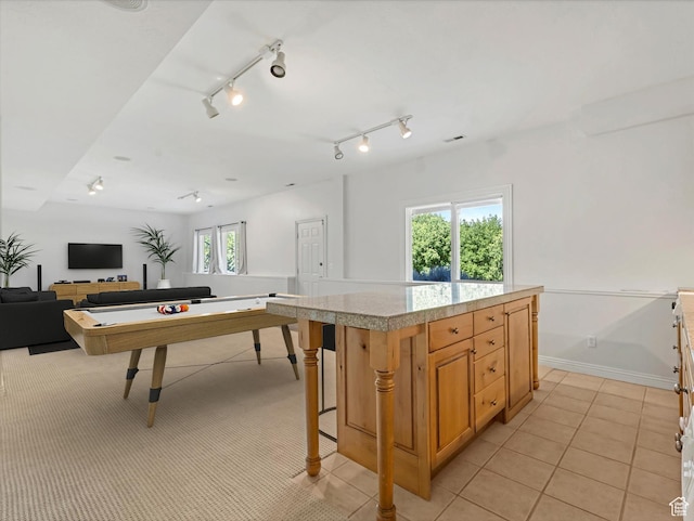 2960 E Oak Park Ln S, Holladay, UT 84117 - kitchen with light countertops, open floor plan, light tile patterned floors, a kitchen island, and a breakfast bar area