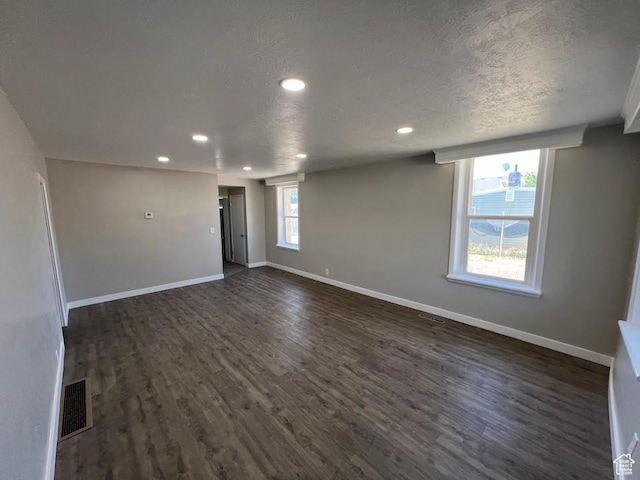 9173 S 1300 W, West Jordan, UT 84088 - unfurnished room featuring dark wood-style flooring, recessed lighting, and a textured ceiling