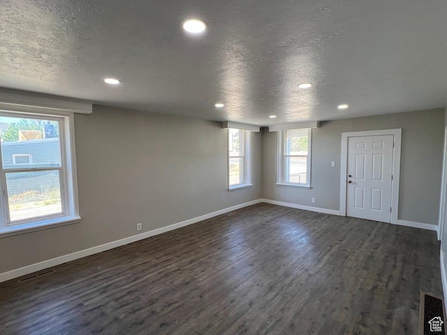 9173 S 1300 W, West Jordan, UT 84088 - unfurnished living room featuring dark wood-type flooring, recessed lighting, and a textured ceiling