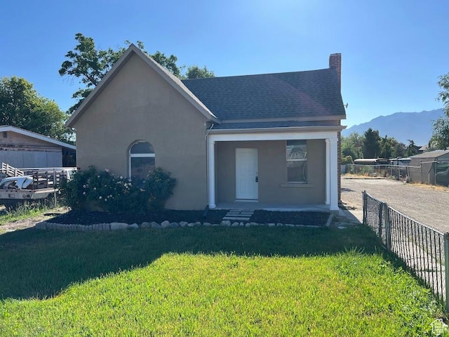 9173 S 1300 W, West Jordan, UT 84088 - view of front of house with a mountain view, stucco siding, covered porch, and a chimney