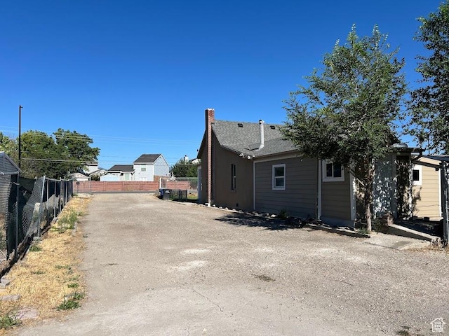 9173 S 1300 W, West Jordan, UT 84088 - view of property exterior featuring a chimney and driveway