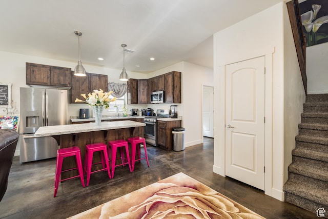 1018 S Valley View Ct, Moab, UT 84532 - kitchen featuring stainless steel appliances, a breakfast bar area, dark brown cabinetry, finished concrete flooring, and recessed lighting