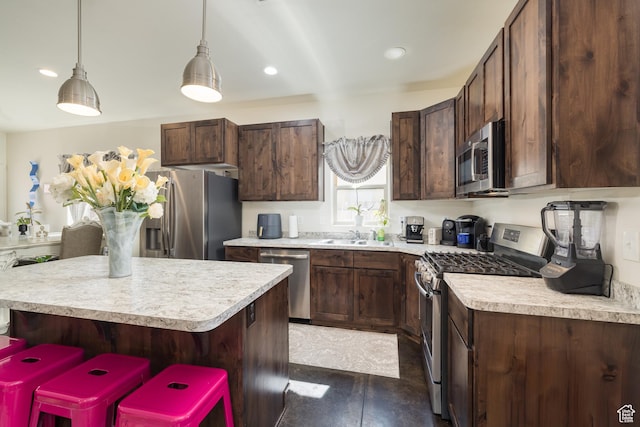 1018 S Valley View Ct, Moab, UT 84532 - kitchen with appliances with stainless steel finishes, light countertops, dark brown cabinets, a center island, and recessed lighting