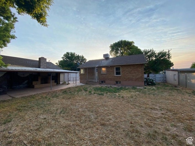 41 N 300 E, Richfield, UT 84701 - back of property at dusk featuring a patio area and a chimney