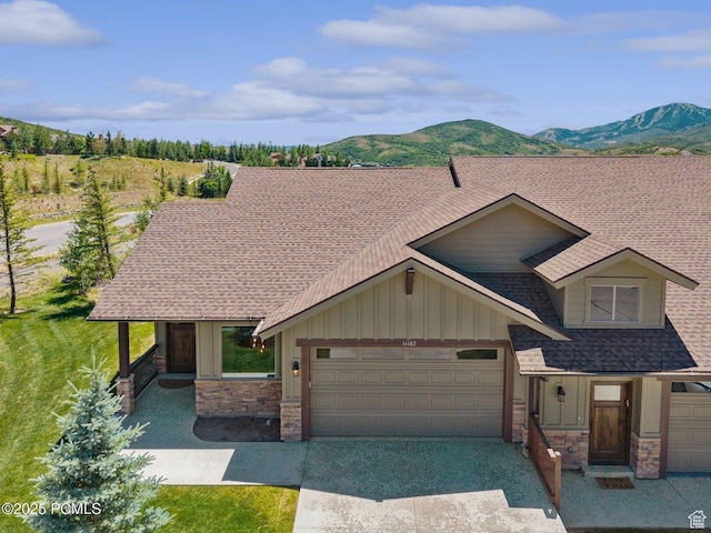 14482 N Buck Horn Trl Unit 50A, Heber City, UT 84032 - view of front of home featuring stone siding, a garage, board and batten siding, and roof with shingles