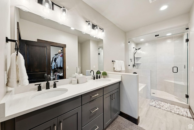 14482 N Buck Horn Trl Unit 50A, Heber City, UT 84032 - bathroom featuring double vanity, a stall shower, a spacious closet, a garden tub, and recessed lighting